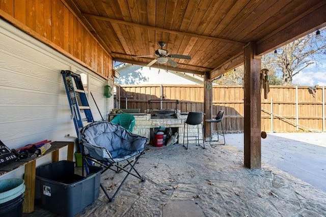 view of patio / terrace with ceiling fan and an outdoor bar