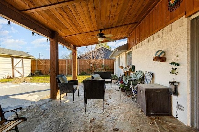 view of patio featuring an outdoor hangout area, ceiling fan, and a storage unit