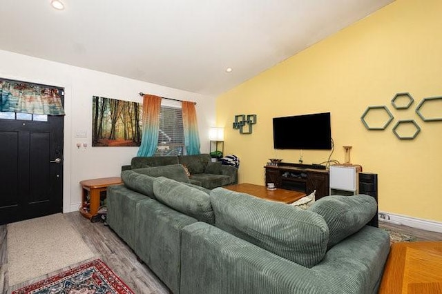 living room featuring lofted ceiling