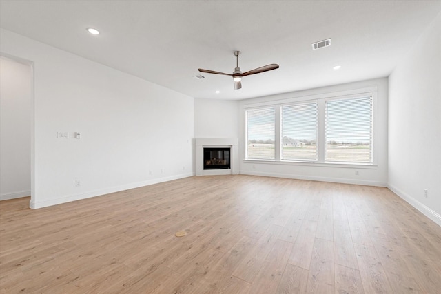 unfurnished living room with light hardwood / wood-style floors and ceiling fan