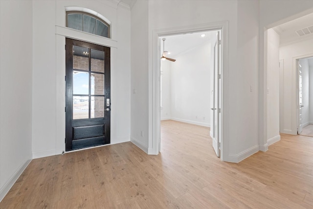 foyer entrance featuring ornamental molding, ceiling fan, and light hardwood / wood-style flooring