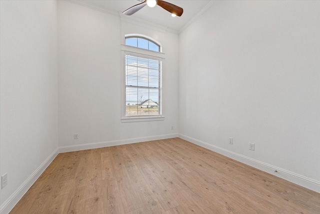 empty room featuring ceiling fan, light wood-type flooring, and crown molding