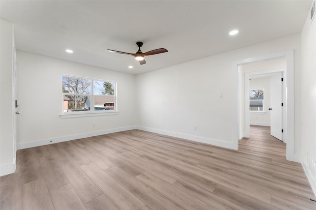 unfurnished room with ceiling fan, a healthy amount of sunlight, and light wood-type flooring