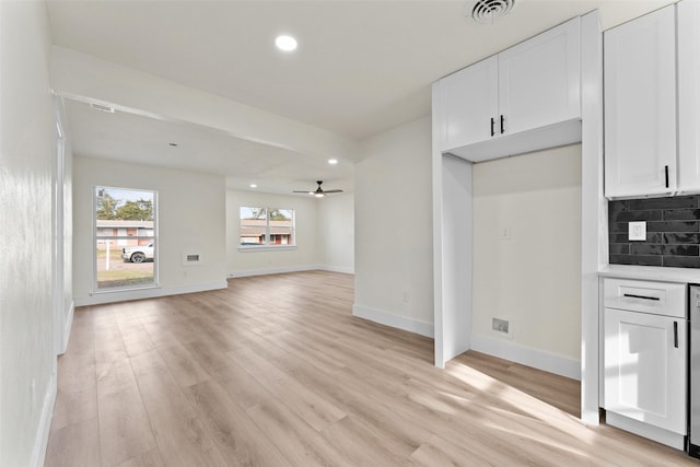 unfurnished living room with ceiling fan and light hardwood / wood-style flooring