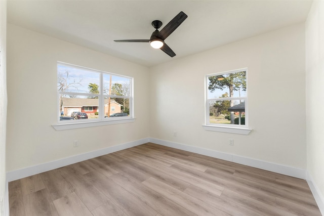 unfurnished room featuring light wood-type flooring, ceiling fan, and a healthy amount of sunlight