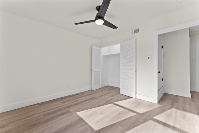 unfurnished bedroom with ceiling fan, light hardwood / wood-style flooring, and a closet