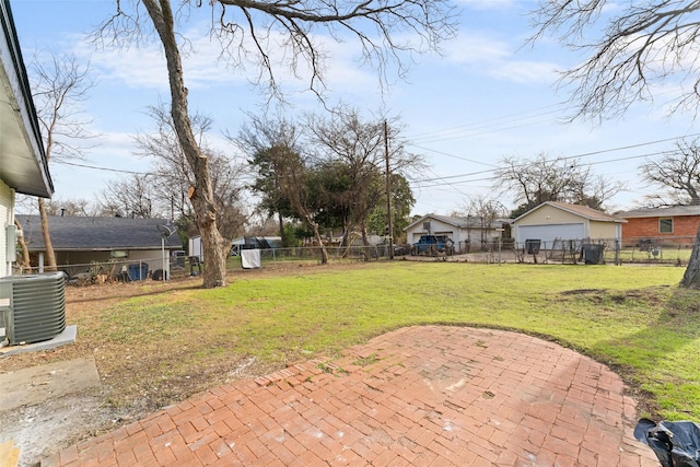 view of yard with central air condition unit and a patio area