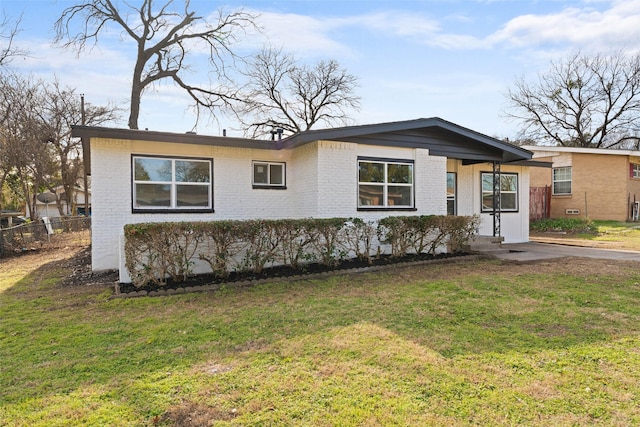 ranch-style home with a front yard