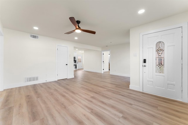 foyer with ceiling fan and light hardwood / wood-style floors