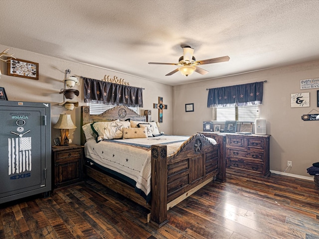 bedroom with a textured ceiling, ceiling fan, and dark hardwood / wood-style floors