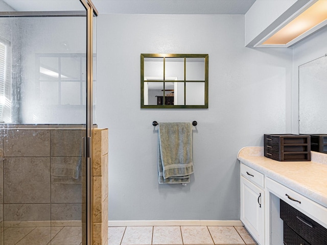 bathroom featuring tile patterned flooring, vanity, and a shower with shower door