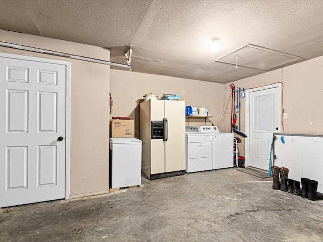 garage with washing machine and clothes dryer and white refrigerator with ice dispenser