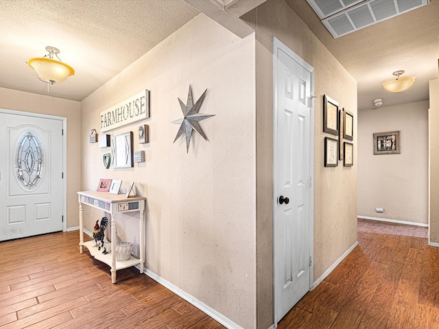 entrance foyer with a textured ceiling and hardwood / wood-style floors