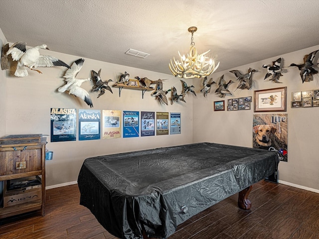 game room with pool table, an inviting chandelier, and a textured ceiling