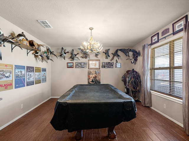 rec room with pool table, an inviting chandelier, a textured ceiling, and dark hardwood / wood-style floors