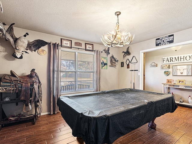 game room featuring pool table, an inviting chandelier, and a textured ceiling