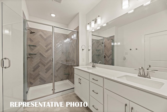 bathroom with tile patterned flooring, vanity, and a shower with shower door