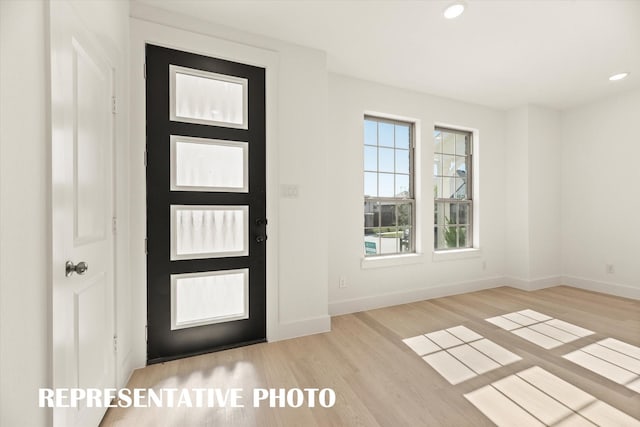 foyer entrance with light hardwood / wood-style floors