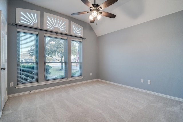 carpeted empty room with vaulted ceiling and ceiling fan