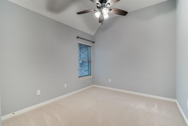 unfurnished room featuring lofted ceiling, ceiling fan, and carpet flooring