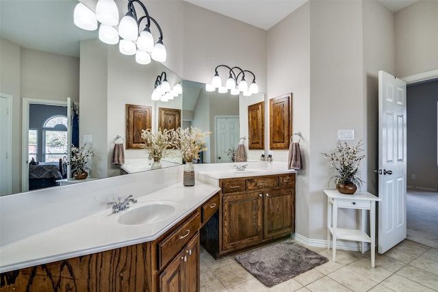 bathroom with vanity, tile patterned flooring, and a high ceiling