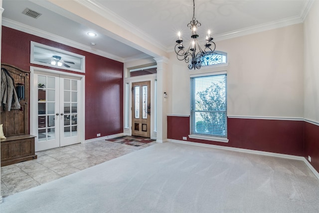 interior space with ornamental molding, ceiling fan with notable chandelier, and french doors