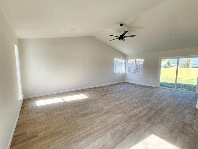 spare room with lofted ceiling, ceiling fan, and light hardwood / wood-style floors