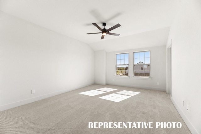 unfurnished room with light carpet, ceiling fan, and vaulted ceiling