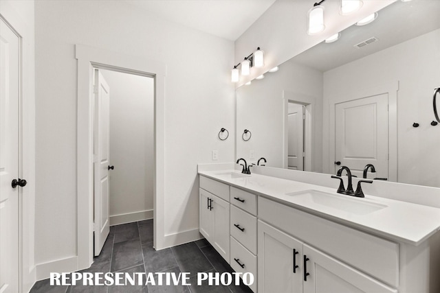 bathroom with tile patterned floors and vanity