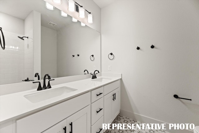 bathroom with tile patterned flooring and vanity