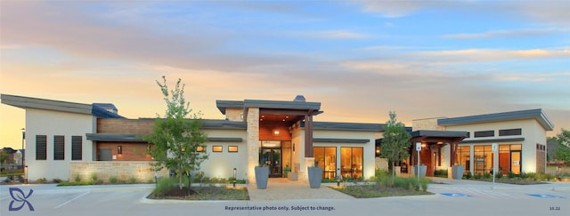 view of outdoor building at dusk