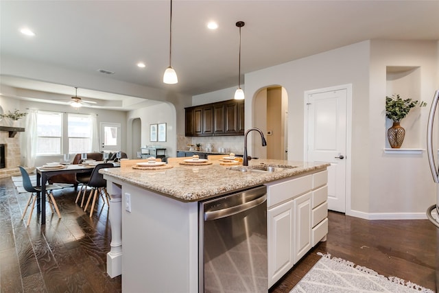 kitchen with sink, white cabinets, dishwasher, dark brown cabinets, and a kitchen island with sink