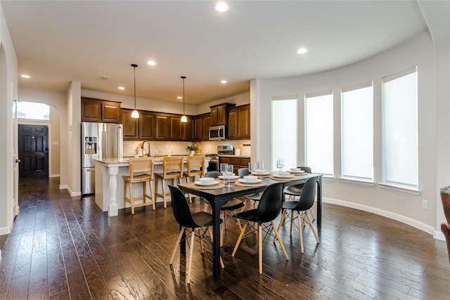 dining area with dark hardwood / wood-style flooring and sink