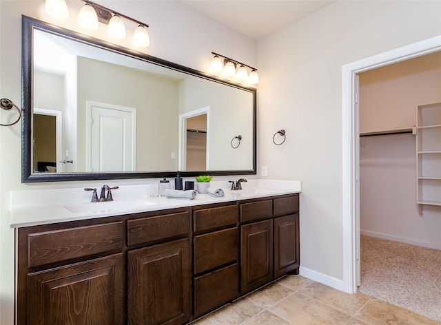 bathroom featuring tile patterned flooring and vanity