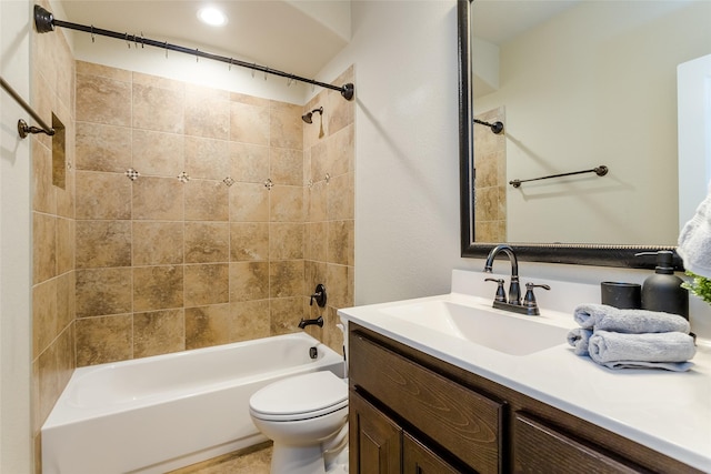 full bathroom with toilet, vanity, and tiled shower / bath combo