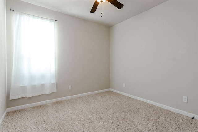 spare room featuring carpet flooring and ceiling fan