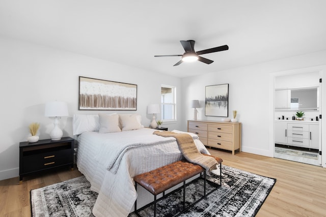 bedroom with ensuite bathroom, ceiling fan, and hardwood / wood-style flooring