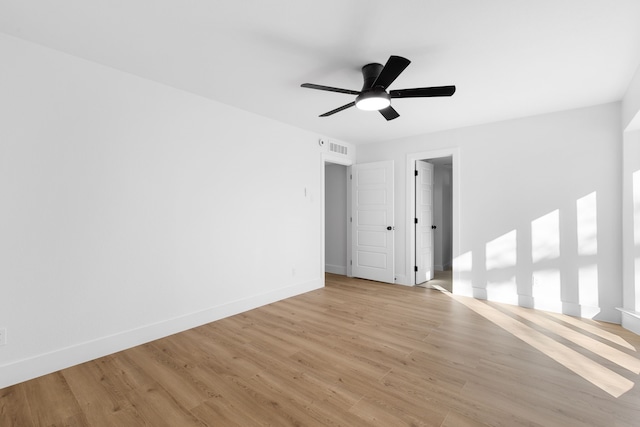 empty room with ceiling fan and light wood-type flooring