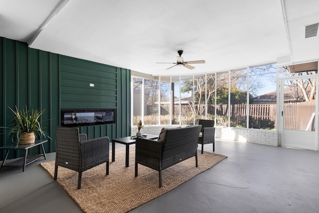 sunroom featuring ceiling fan and a healthy amount of sunlight