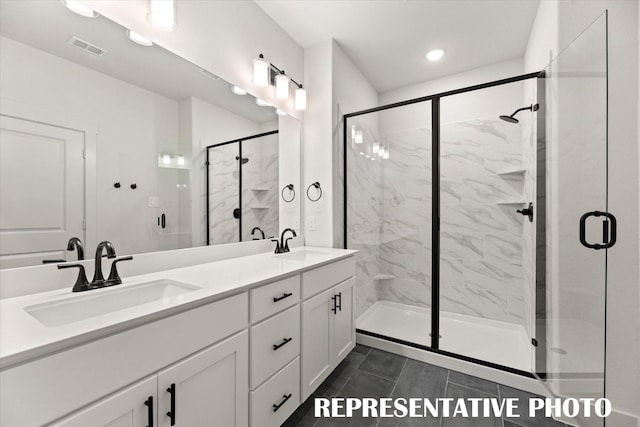 bathroom featuring tile patterned flooring, a shower with shower door, and vanity