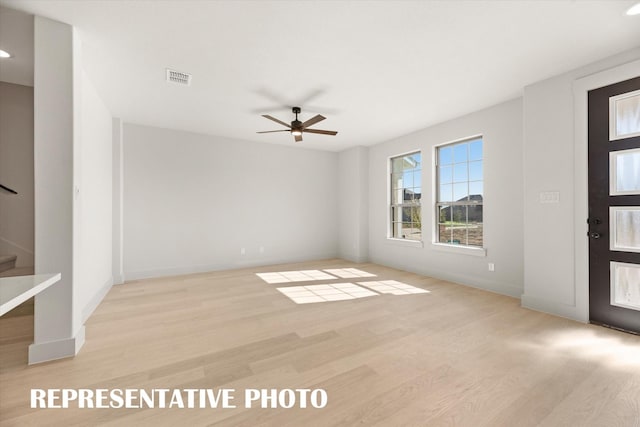 unfurnished room with light wood-type flooring and ceiling fan