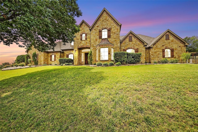 view of front of home with a lawn