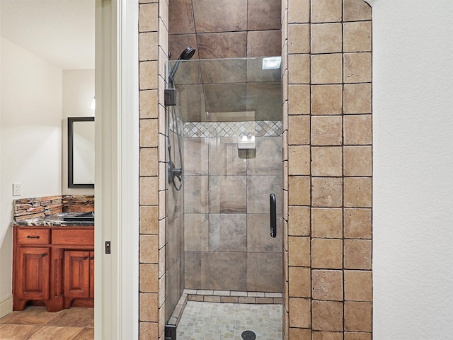 bathroom with a shower with door and vanity