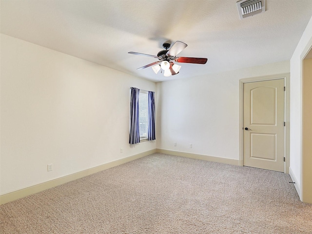 spare room featuring ceiling fan and carpet flooring