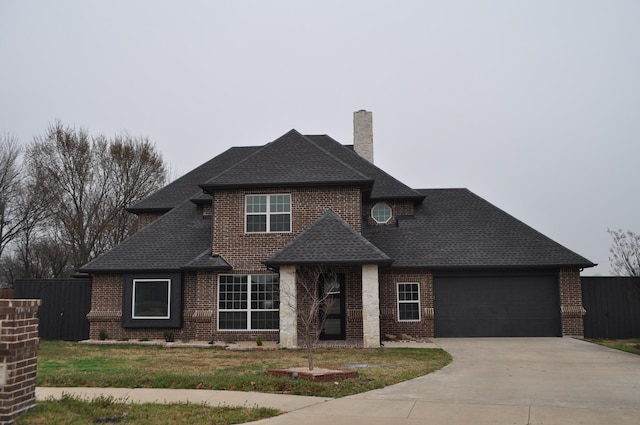 view of front of house featuring a garage and a front lawn