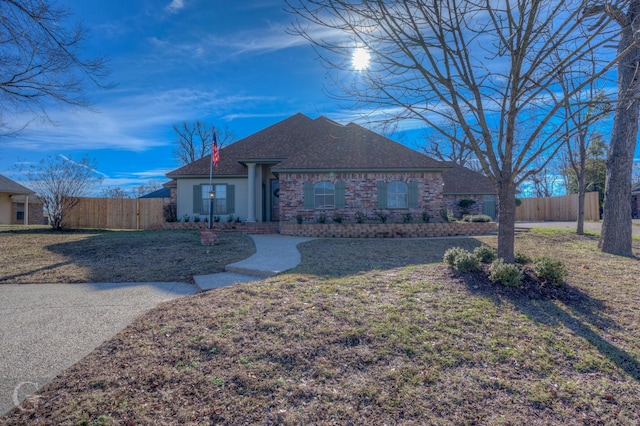 ranch-style home featuring a front yard