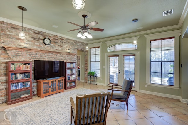 tiled living room featuring ornamental molding, ceiling fan, french doors, and brick wall