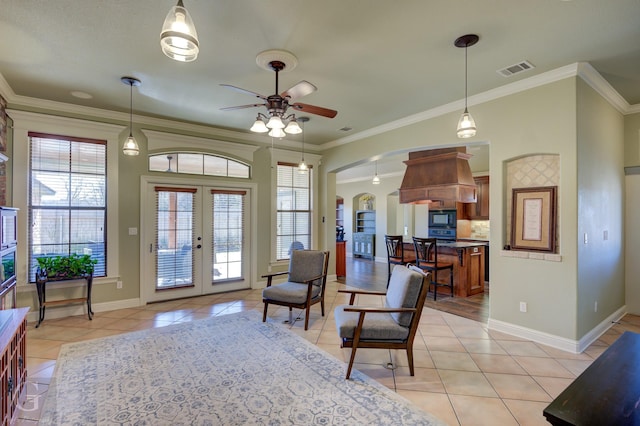 interior space featuring ceiling fan, light tile patterned flooring, french doors, and crown molding