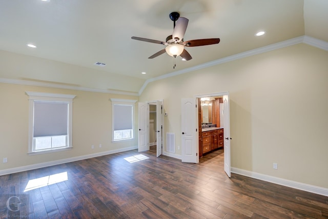 spare room featuring ceiling fan, ornamental molding, vaulted ceiling, and dark hardwood / wood-style floors