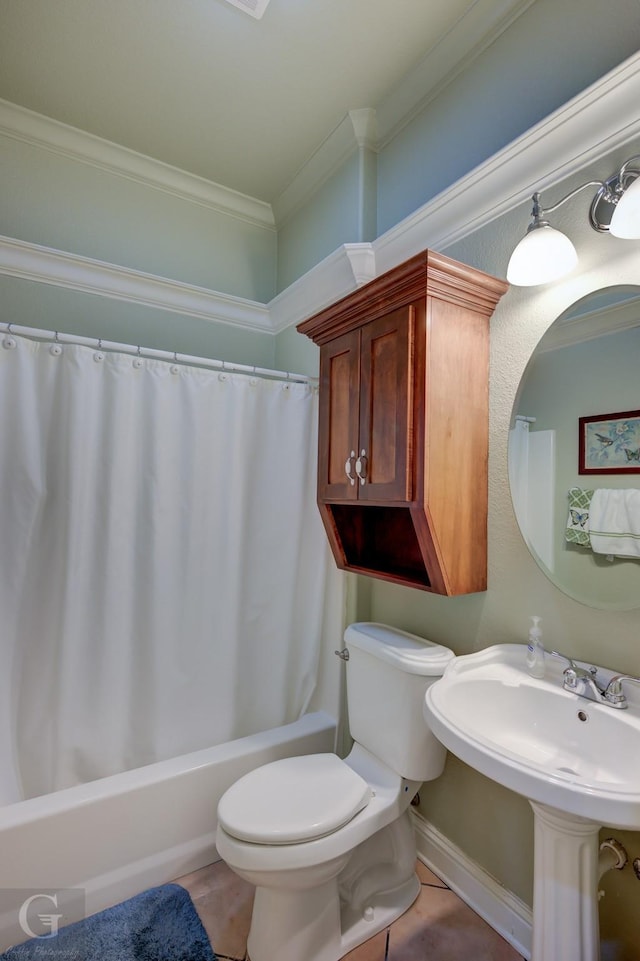 bathroom with toilet, tile patterned flooring, ornamental molding, and sink